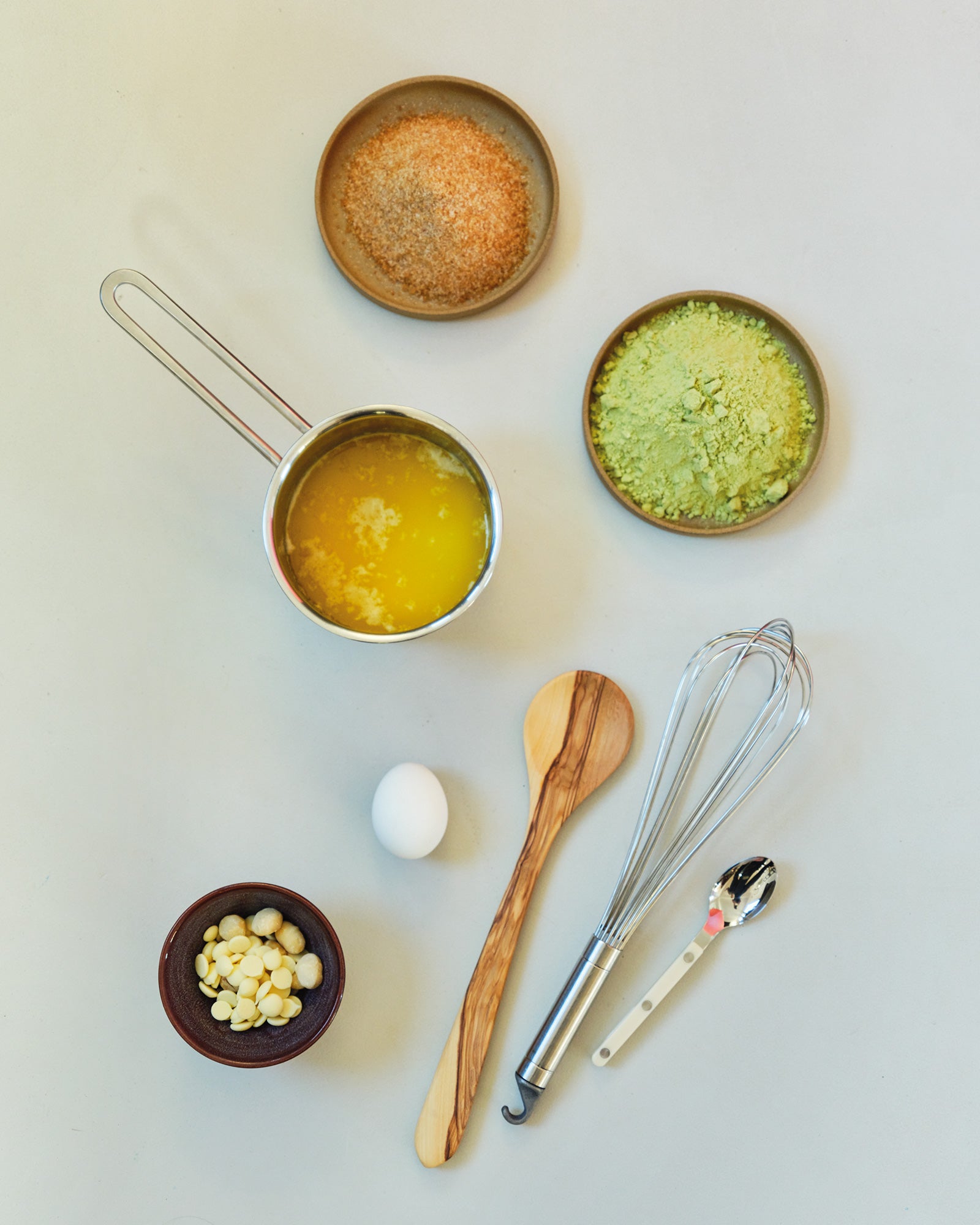 matcha cookies ingredients and utensils on a light surface